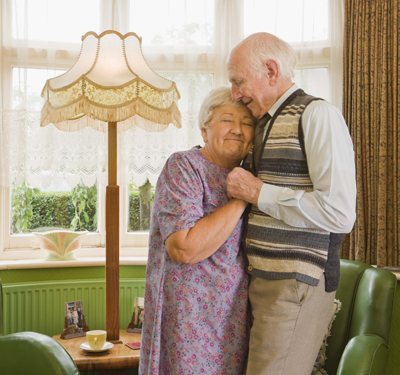 Elderly couple dancing at home